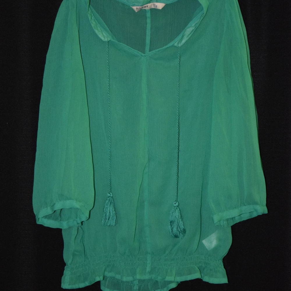 Sheer, green blouse with tassels