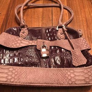 Purple bag with silver lock hardware.