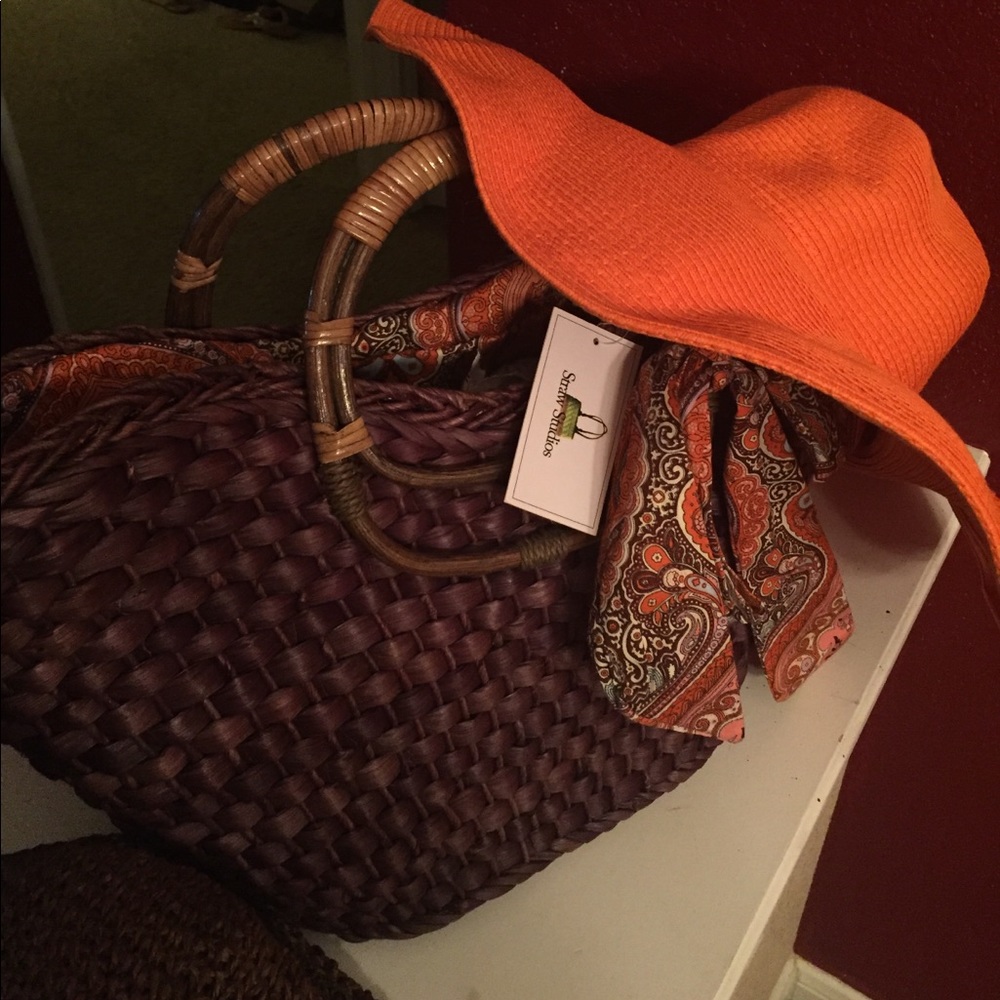 Floppy orange beach hat with a brown straw bag