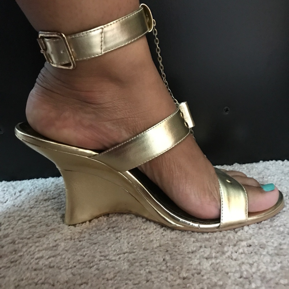 Gold wedge heels.