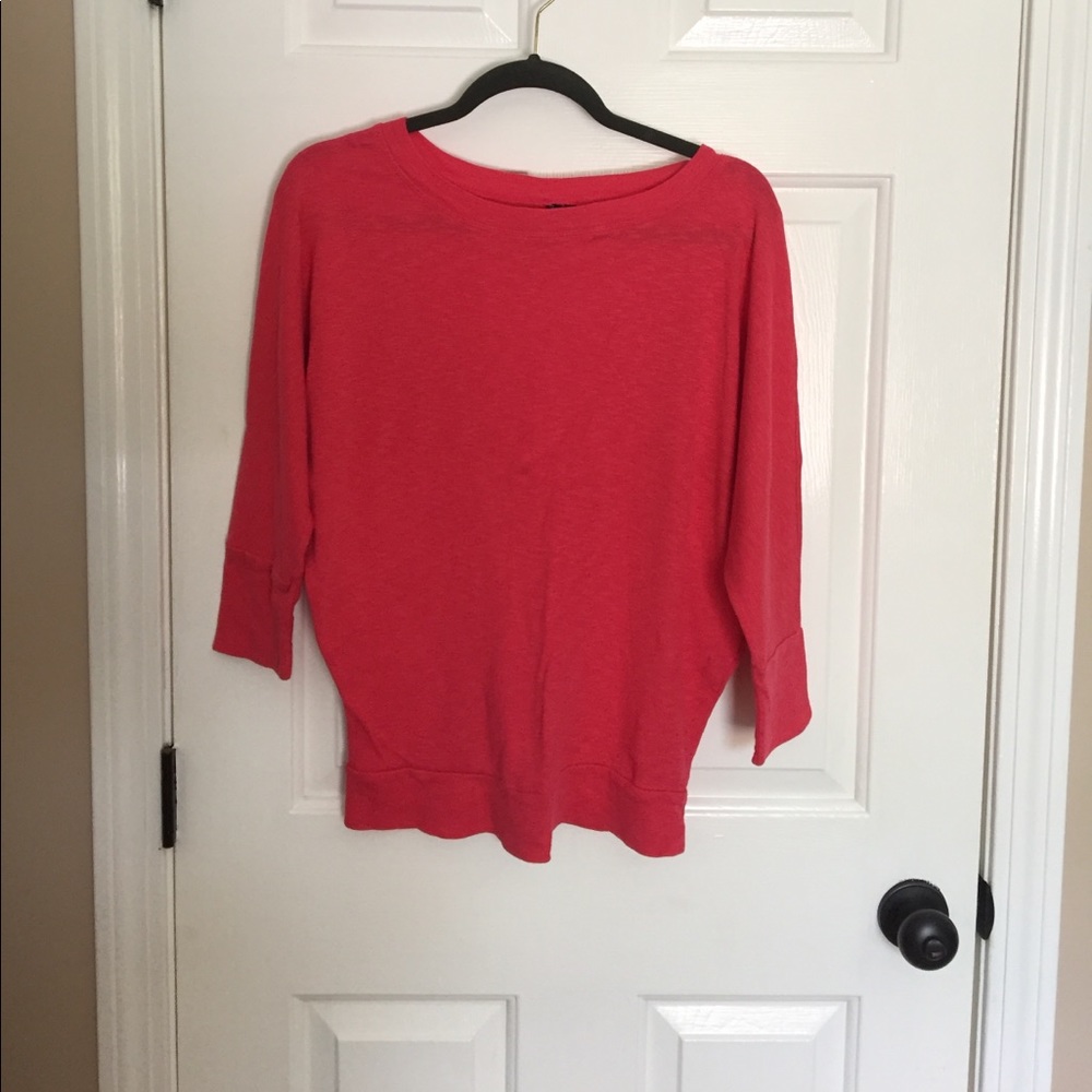 Pink three-quarter length sleeve shirt.