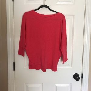 Pink three-quarter length sleeve shirt.