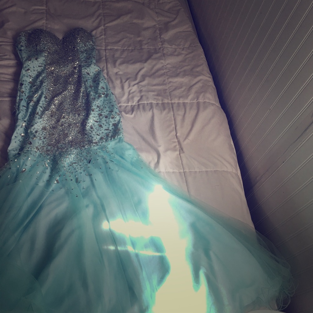 An aqua blue crystal covered prom dress