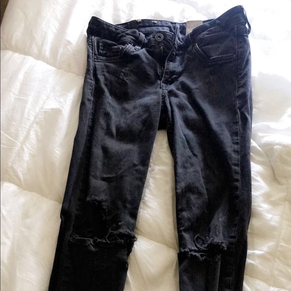 Mid rise knee slit super skinny jeans