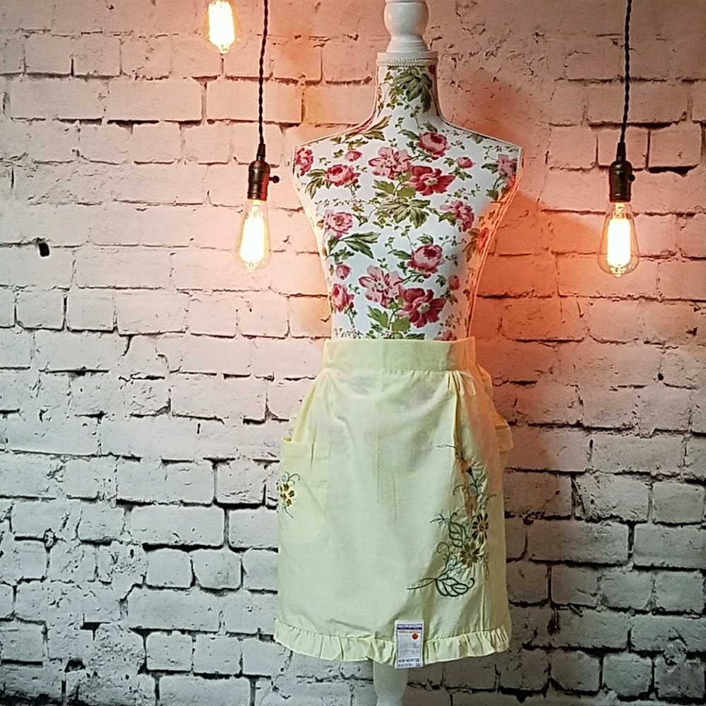 Vintage apron. Pale yellow with embroidery flowers