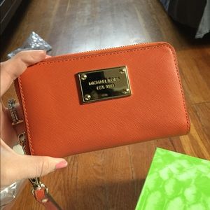 Michael kors wristlet/orange in color