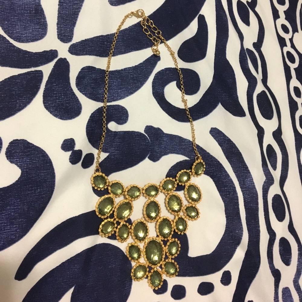Statement gold necklace with pale green gems
