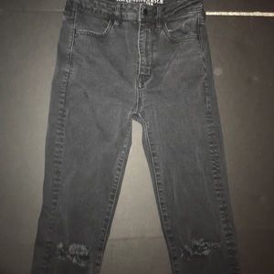 Black high rise skinny jeans with slits in knees