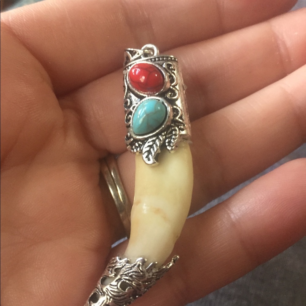 Real turquoise silver capped wolf tooth pendant.