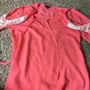 Cute coral summer shirt open on shoulder
