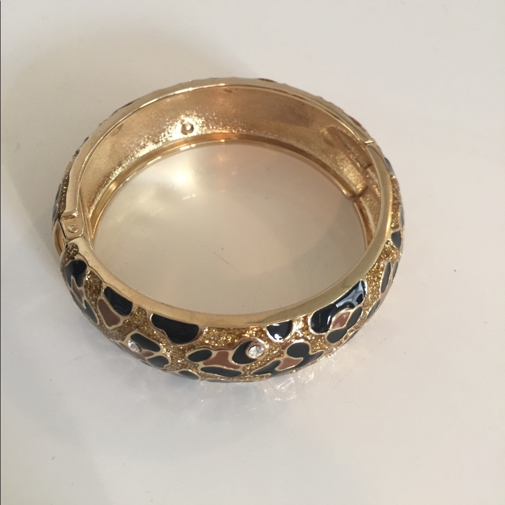 Leopard print with crystals cuff. Hinge closure.