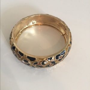Leopard print with crystals cuff. Hinge closure.