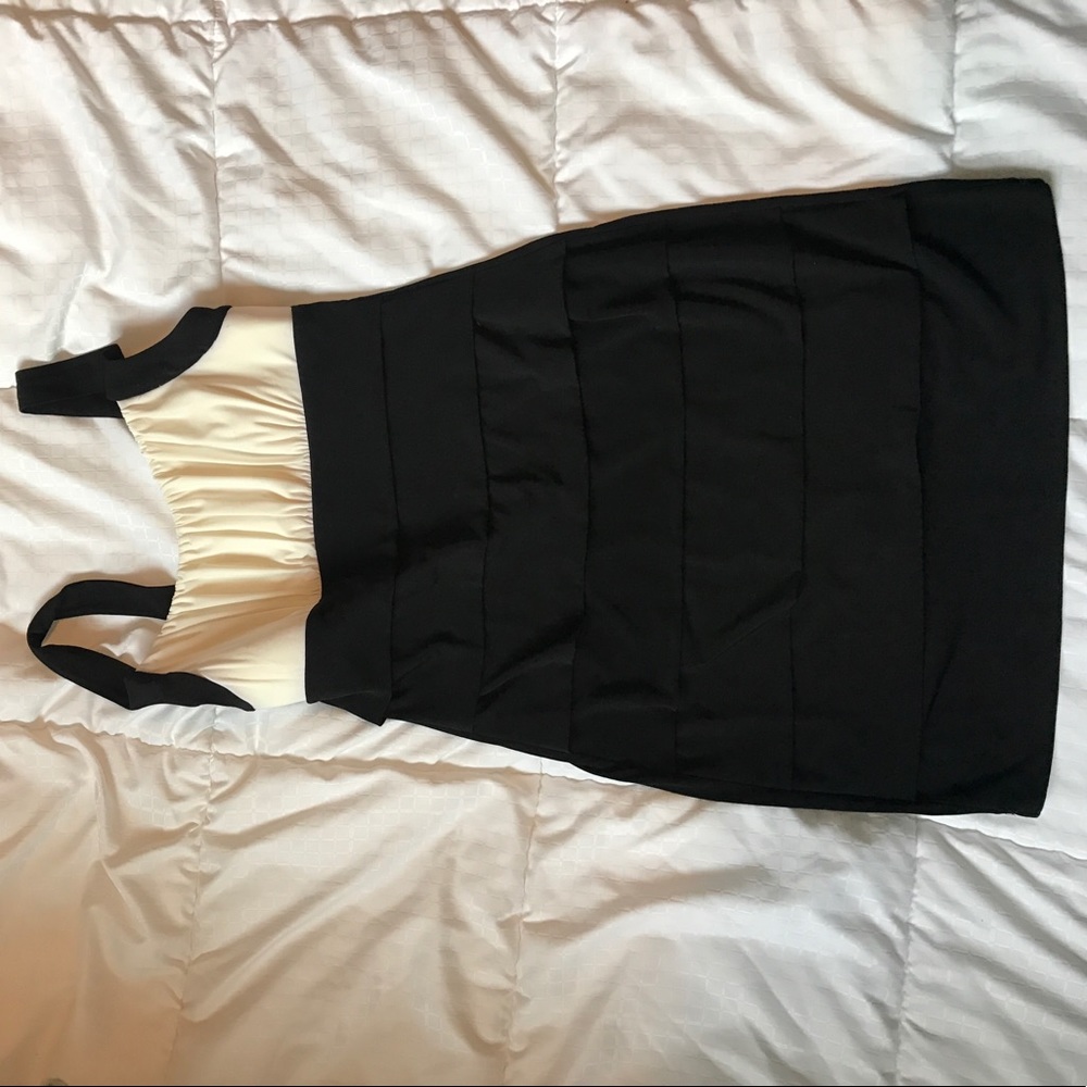 Black and white mini dress, form fitting.