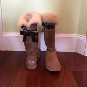 Tall chestnut ugg boots with bow. Never been worn.
