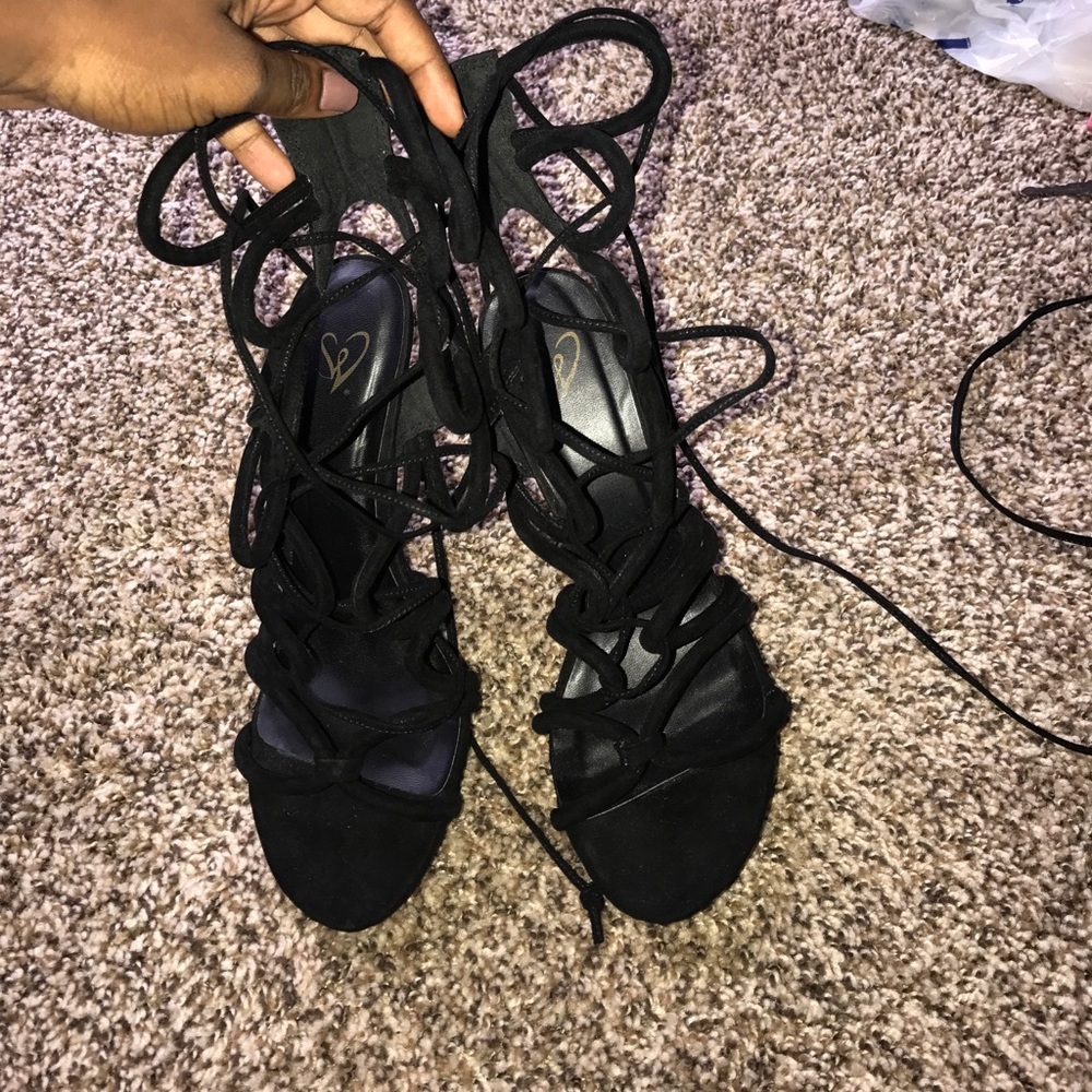 Lace up black heels.