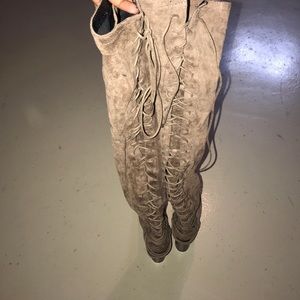 Thigh high lace up boots.