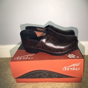 Brown snake skin Dansko clogs.