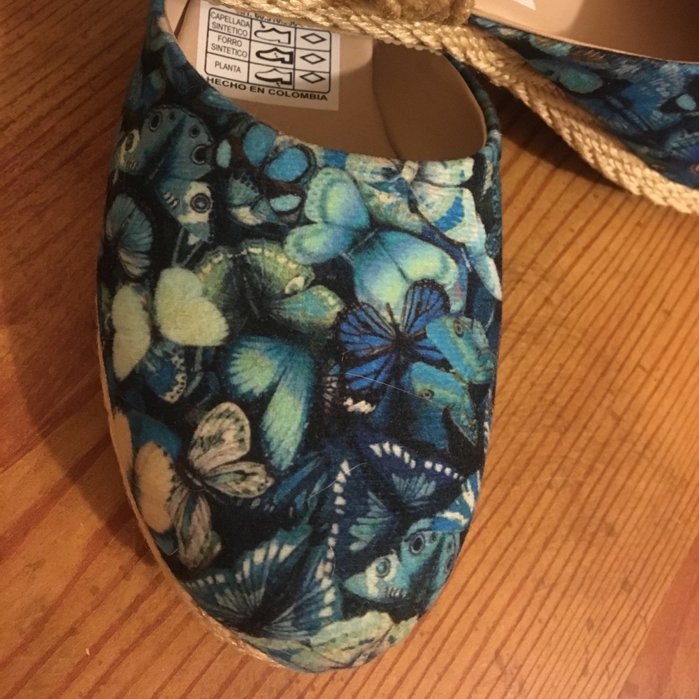 Flats with a blue butterfly pattern