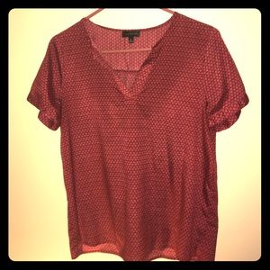 Red patterned v neck blouse
