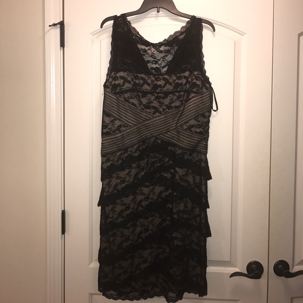 Black lace cocktail dress with nude underlay.