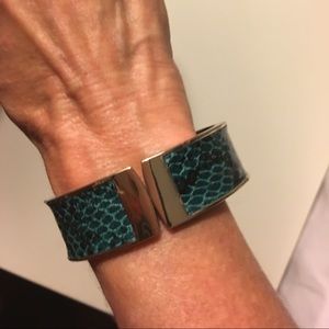 Green bracelet with darker specks, opens up