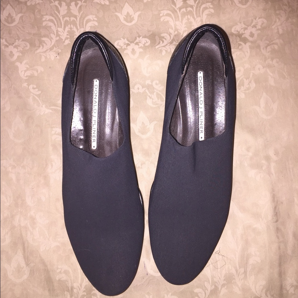 Black loafer with a wedge heel.