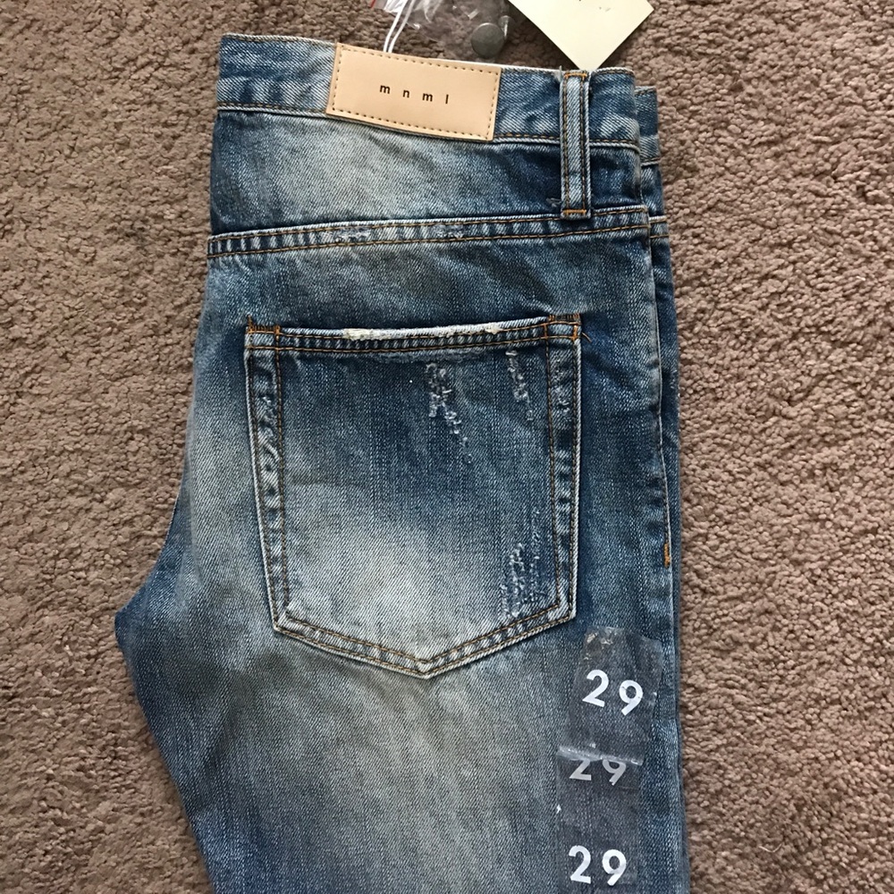 Men's MNML ripped tapered ankle zip jeans.