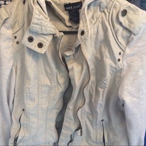 A cream colored jacket, with edgy detailing