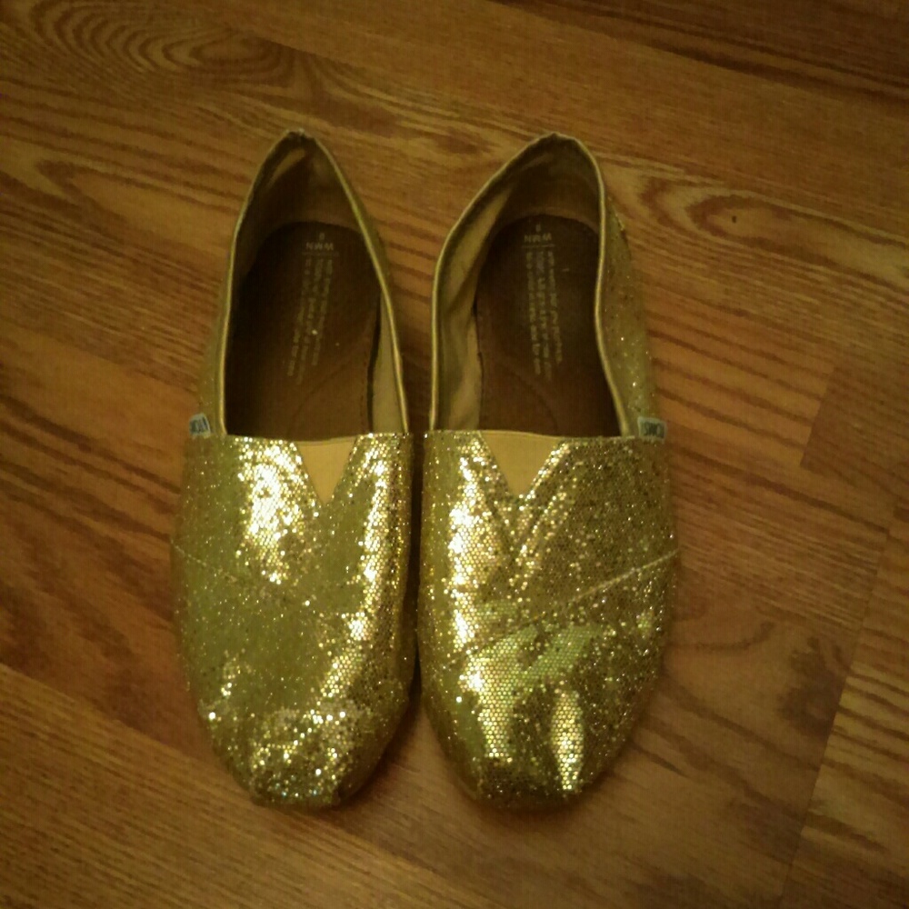 Gold glitter TOMS shoes