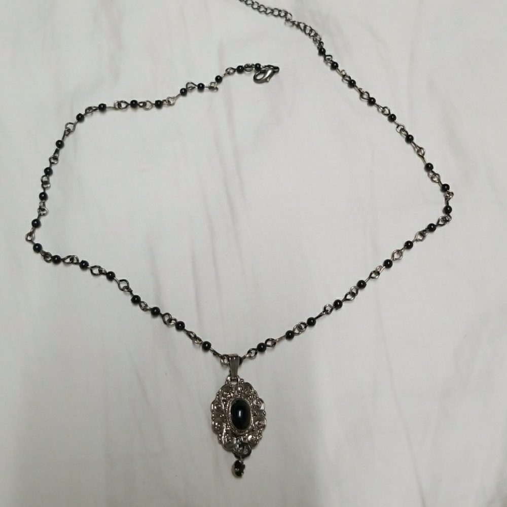 Adjustable black choker with silver medallion