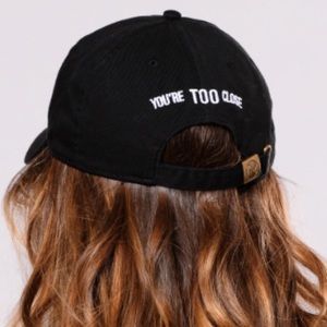 Black baseball cap: You're Too Close