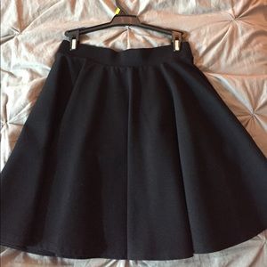 black pleated a-line mini skirt