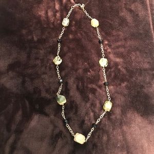 Gold necklace with green stones and black beads