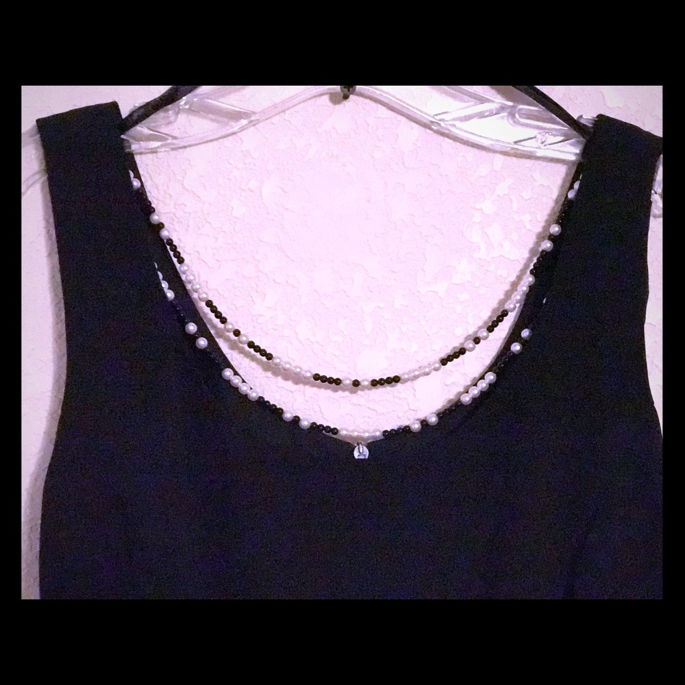Black dress with pearl necklace attached