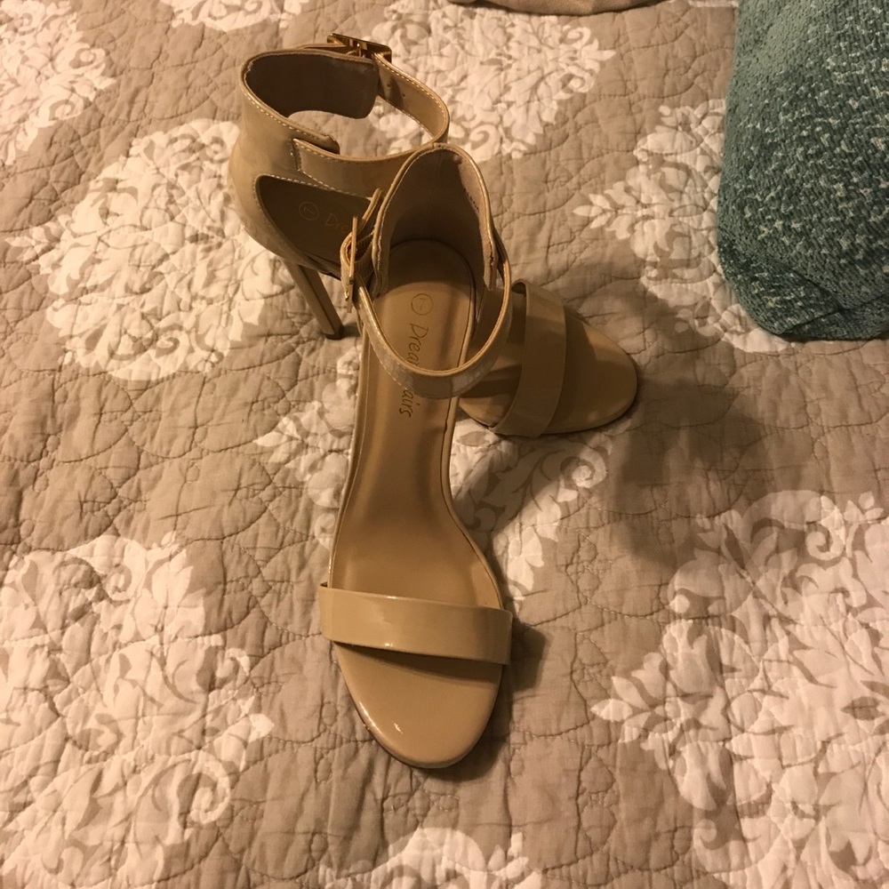 Tan glossy strapy heels.