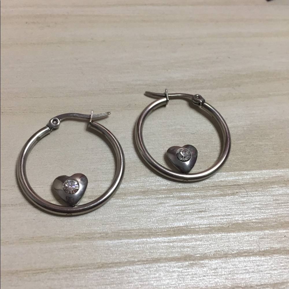 Small hoop earrings with tiny heart at the bottom