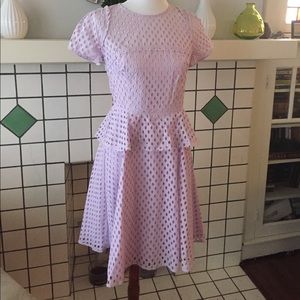 Lilac dress with peplum.