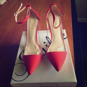 Never been worn red and clear pumps