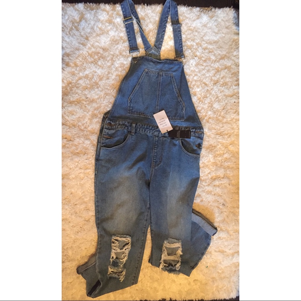 Destroyed denim overalls