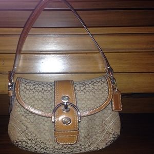 Medium sized Coach purse. Fits on your shoulder.