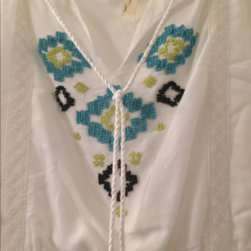 Adorable white dress with beaded details.