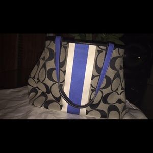 A blue and black coach bag.