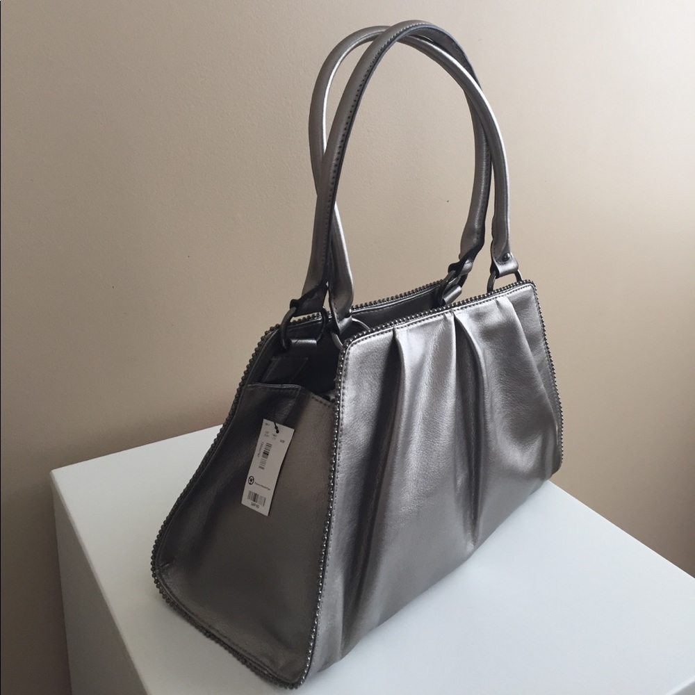 New with tags silver metallic purse.