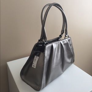New with tags silver metallic purse.