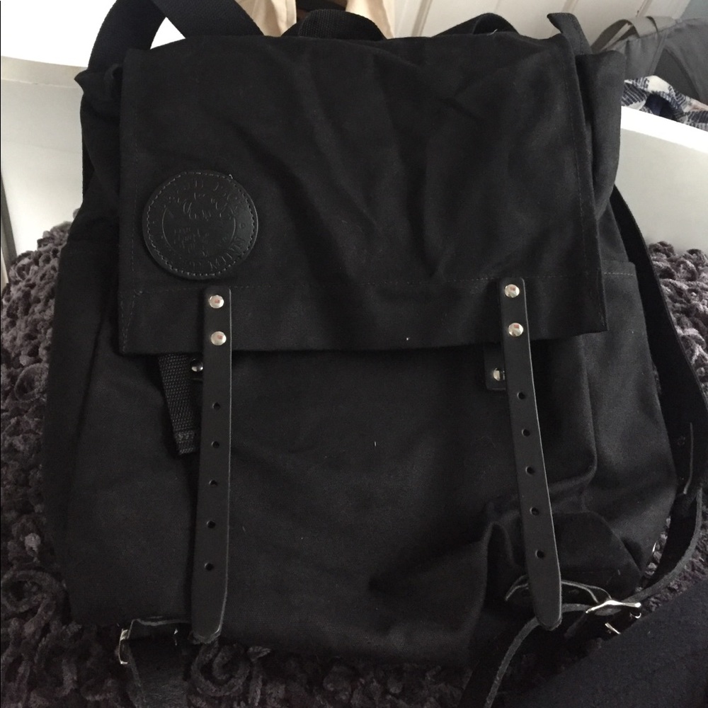 black canvas backpack with belts for straps