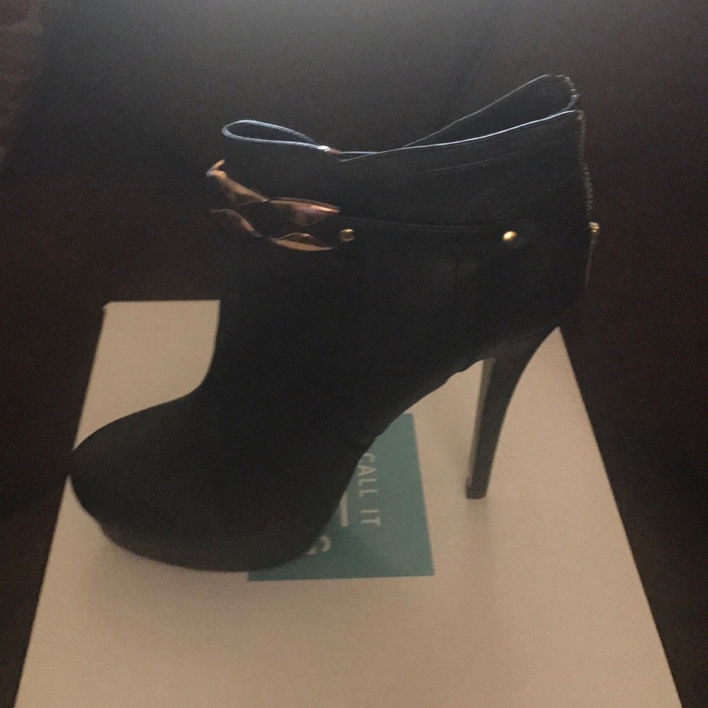 Black booties with gold accents.
