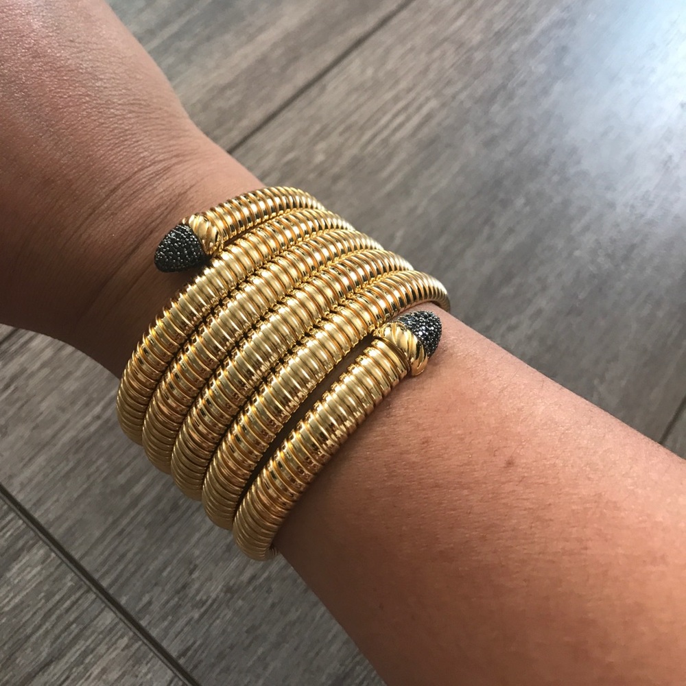 NWOT gold tone Tubagas wrap bracelet.