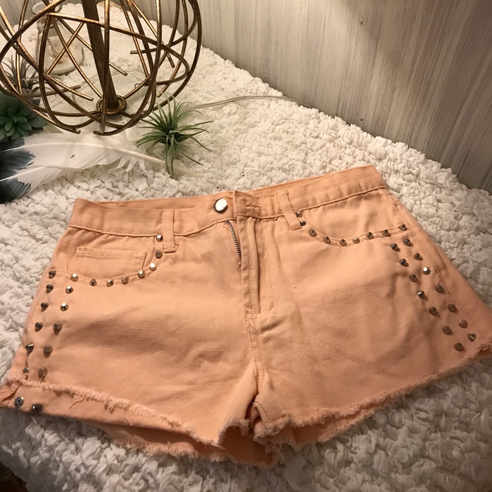 Peach studded shorts.