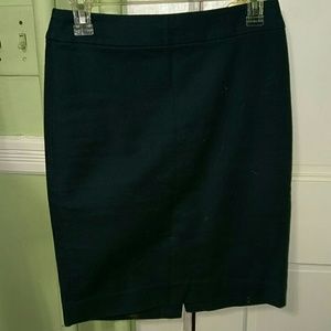 Dark green or teal skirt