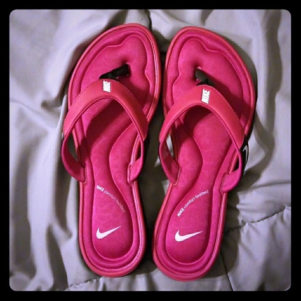 Pink and  black Nike flip flops